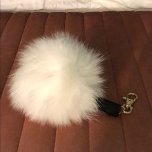 Puff ball keychain with iPhone charger built in
